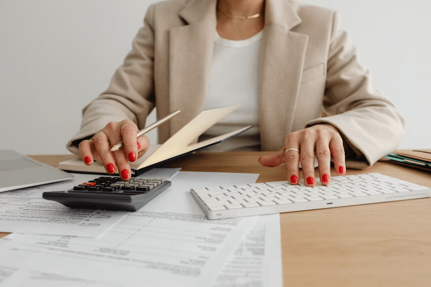Person reviewing exchange fees and calculating the final amount of foreign currency before confirming a currency exchange.